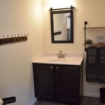 a bathroom with a mirror and a sink