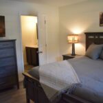 a bedroom with a bed and a dresser