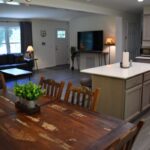 a living room with a table and chairs