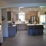 a kitchen with a bar and a wood floor