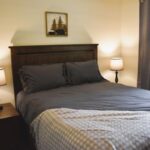 a bed with a lamp on the side