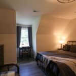 a bedroom with a bed and a lamp