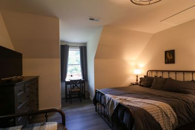 a bedroom with a bed and a lamp