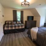 a bedroom with a bed and a tv