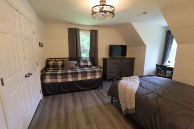 a bedroom with a bed and a tv